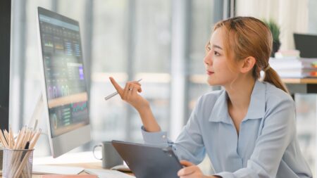 a woman looking at a screen as she is sat down